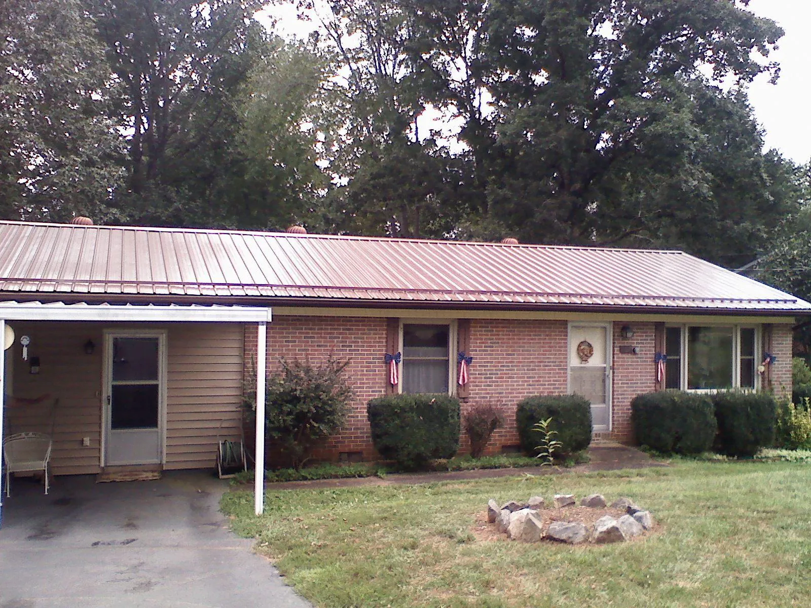 Bronze metal roof and carport on a brick ranch home — Roof Repair work by our crew in Lincolnwood